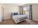 Bedroom with neutral walls, plush carpeting, and a large window offering natural light at 5555 Perth Ct, Denver, CO 80249