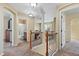 Upstairs hallway with neutral walls and carpet, leading to multiple rooms at 5555 Perth Ct, Denver, CO 80249