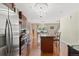 Bright kitchen featuring a large island with seating and stainless steel appliances at 5555 Perth Ct, Denver, CO 80249