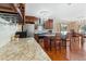Kitchen with wooden cabinets, granite counters, stainless appliances and island at 5555 Perth Ct, Denver, CO 80249