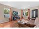 Cozy living room featuring a fireplace, hardwood floors, and large windows for ample natural light at 5555 Perth Ct, Denver, CO 80249