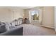 Inviting living room space complete with a comfortable couch, workspace, and natural light at 5555 Perth Ct, Denver, CO 80249