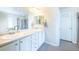 Double vanity bathroom with white cabinets and a large mirror at 1682 Dorothy Cir, Longmont, CO 80503