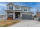 Two-story house with gray siding, stone accents, and a two-car garage at 1682 Dorothy Cir, Longmont, CO 80503