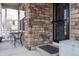 Front entrance with stonework, black door, and a decorative welcome mat at 1682 Dorothy Cir, Longmont, CO 80503