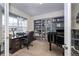 Home office with built-in shelving, desk, and a black piano at 1682 Dorothy Cir, Longmont, CO 80503