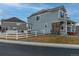 Two-story house with gray siding, white fence, and landscaped yard at 1682 Dorothy Cir, Longmont, CO 80503