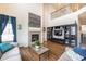 Living room with hardwood floors, fireplace, built-in shelving, and high ceilings at 1682 Dorothy Cir, Longmont, CO 80503