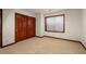 Basement bedroom with double-door closet and window at 4272 E Orchard Pl, Centennial, CO 80121