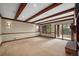 Bright, spacious basement recreation room with wood beams and sliding doors at 4272 E Orchard Pl, Centennial, CO 80121