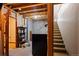 Unfinished basement area with storage shelving and stairs at 4272 E Orchard Pl, Centennial, CO 80121