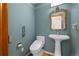 Powder room with pedestal sink, toilet and decorative mirror at 4272 E Orchard Pl, Centennial, CO 80121