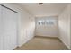 Simple bedroom with double-door closet and window at 4272 E Orchard Pl, Centennial, CO 80121