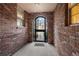 View through entryway shows brick walls and arched gate at 4272 E Orchard Pl, Centennial, CO 80121