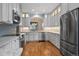 Modern kitchen features stainless steel appliances and hardwood floors at 4272 E Orchard Pl, Centennial, CO 80121