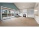 Living room with fireplace, built-in shelving and access to deck at 4272 E Orchard Pl, Centennial, CO 80121