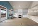 Living room with fireplace, built-in shelving and access to deck at 4272 E Orchard Pl, Centennial, CO 80121