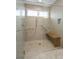 Large walk-in shower with built-in seat and multiple shower heads at 4272 E Orchard Pl, Centennial, CO 80121