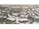 Breathtaking aerial view of snow-covered rooftops and trees in a charming mountain community at 290 Broken Lance Dr # B202, Breckenridge, CO 80424