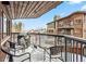 Exterior view of a covered balcony with seating, grill, and snowy mountain views at 290 Broken Lance Dr # B202, Breckenridge, CO 80424