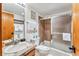 Functional bathroom with shower-tub combo, single sink vanity, and neutral tile at 290 Broken Lance Dr # B202, Breckenridge, CO 80424