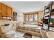 Bright bathroom featuring a soaking tub, toilet, tile floors and walls, and views of the snow covered forest at 290 Broken Lance Dr # B202, Breckenridge, CO 80424