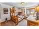 Rustic bedroom featuring a log bunk bed, dresser, and cozy decor with a mountain theme at 290 Broken Lance Dr # B202, Breckenridge, CO 80424