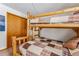 Cozy bedroom features a rustic wooden bunk bed with a colorful patchwork quilt, next to a closet at 290 Broken Lance Dr # B202, Breckenridge, CO 80424