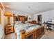Large bedroom with a wooden bed, bedside table, desk and chair, and closet for lots of storage space at 290 Broken Lance Dr # B202, Breckenridge, CO 80424