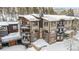 Close-up of a condo building showing balconies and stone chimney, covered in winter snow at 290 Broken Lance Dr # B202, Breckenridge, CO 80424