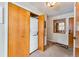 Hallway featuring a stacked washer and dryer hidden behind folding doors, near the entryway at 290 Broken Lance Dr # B202, Breckenridge, CO 80424