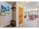 Hallway entryway with wood door, coat rack, bench, and view into the open-concept living space at 290 Broken Lance Dr # B202, Breckenridge, CO 80424