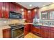 Close-up of kitchen area, showcasing wooden cabinets, tile backsplash, and stainless steel appliances at 290 Broken Lance Dr # B202, Breckenridge, CO 80424