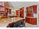 Well-equipped kitchen with granite countertops, wood cabinets, and a breakfast bar at 290 Broken Lance Dr # B202, Breckenridge, CO 80424