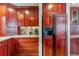 Cherry wood cabinets and drawers surround a black refrigerator in this beautifully appointed kitchen at 290 Broken Lance Dr # B202, Breckenridge, CO 80424