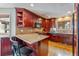 Cozy kitchen featuring wood cabinets, granite countertops, stainless appliances, and breakfast bar seating at 290 Broken Lance Dr # B202, Breckenridge, CO 80424