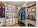 Walk-in closet with custom shelving and racks provides ample storage space for clothes, shoes, and accessories at 290 Broken Lance Dr # B202, Breckenridge, CO 80424