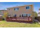 Exterior showcasing a large deck, expansive windows, and a manicured lawn, offering a private outdoor space for relaxation at 4901 Ashbrook Cir, Highlands Ranch, CO 80130