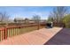 Spacious backyard deck with wooden railings and a view of the landscaped yard at 4901 Ashbrook Cir, Highlands Ranch, CO 80130