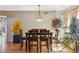 Dining area featuring hardwood floors and a wooden dining table with chairs and natural light at 4901 Ashbrook Cir, Highlands Ranch, CO 80130