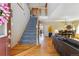Welcoming foyer with hardwood floors, staircase, and view into the open living and dining areas at 4901 Ashbrook Cir, Highlands Ranch, CO 80130