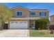Charming two-story home featuring a well-maintained front yard, two-car garage, and solar panels at 4901 Ashbrook Cir, Highlands Ranch, CO 80130