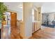 Hallway with wood floors leading to an exercise room, showing natural light at 4901 Ashbrook Cir, Highlands Ranch, CO 80130