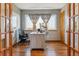Bright home office with wood floors, a desk, chair, and large windows at 4901 Ashbrook Cir, Highlands Ranch, CO 80130