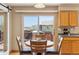 Bright kitchen features a sliding door to the deck and a table for dining at 4901 Ashbrook Cir, Highlands Ranch, CO 80130