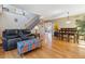 Open-concept living area with a staircase, hardwood floors, and views of dining area and sliding barn doors at 4901 Ashbrook Cir, Highlands Ranch, CO 80130