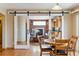 Cozy dining area offering views into a living room with fireplace and an adjacent kitchen area at 4901 Ashbrook Cir, Highlands Ranch, CO 80130