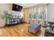 Inviting living room with hardwood floors, large windows, and cozy seating and a console at 4901 Ashbrook Cir, Highlands Ranch, CO 80130