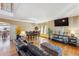 Bright living room with hardwood floors, large windows, comfortable seating, and adjacent dining area at 4901 Ashbrook Cir, Highlands Ranch, CO 80130