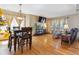 Open-concept living area with hardwood floors, dining table, media center, and plenty of natural light at 4901 Ashbrook Cir, Highlands Ranch, CO 80130